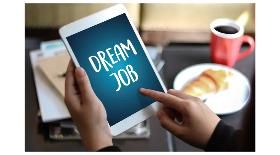 Tablet screen displaying 'Dream Job' text with a coffee and pastry, symbolizing the search for well-paying jobs.
