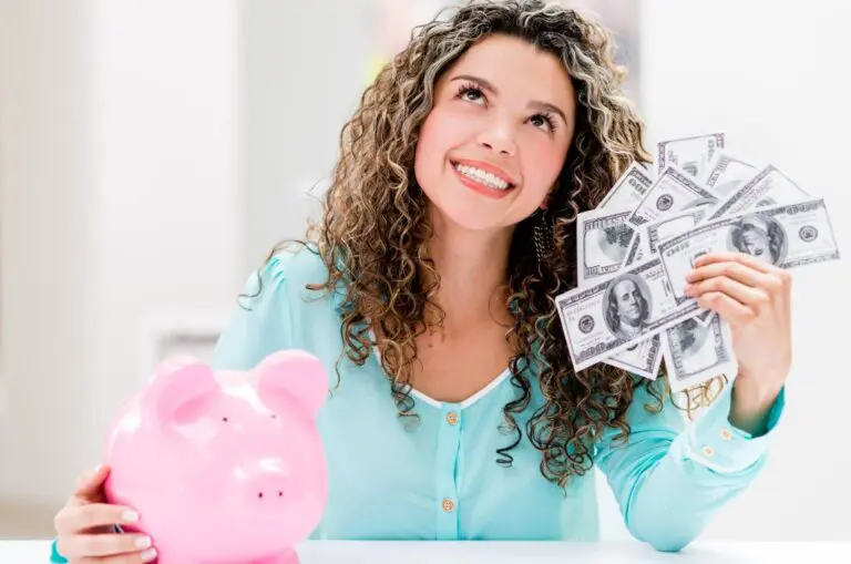 Happy woman holding cash with a piggy bank, representing the joy of meeting money saving challenges.