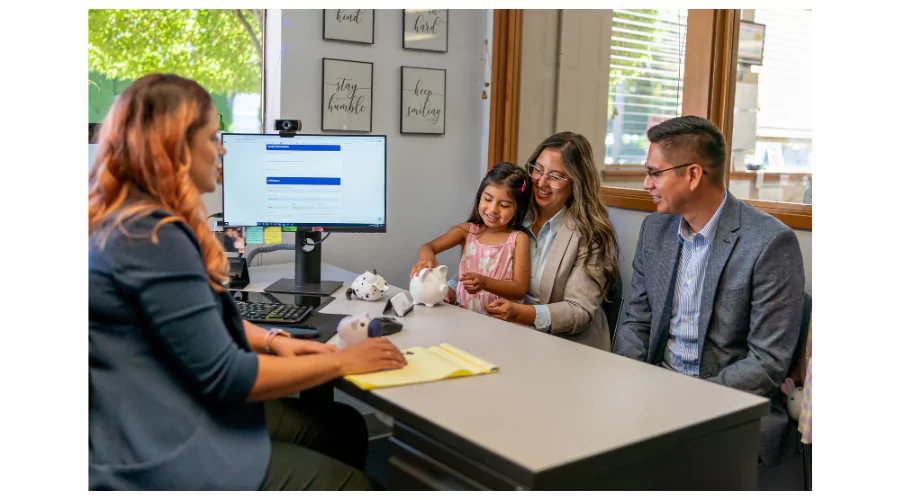 Family at a bank consultant's desk, opening an Ally child account for financial literacy.