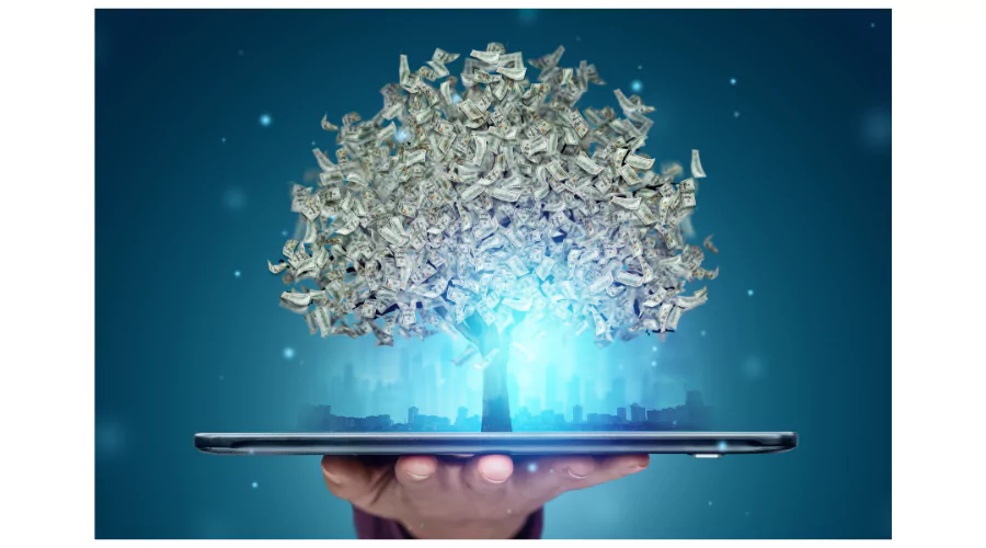 Hand holding a tablet with a digital tree growing money, symbolizing investment growth and passive income opportunities.