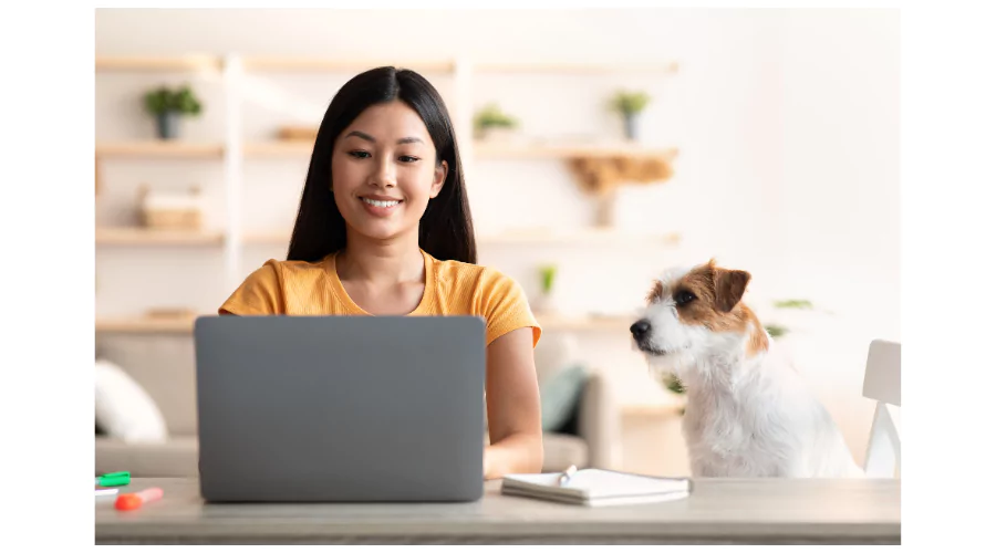 Cheerful asian woman independent contractor dog owner working from home