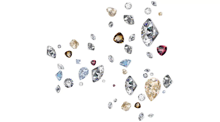 Various gemstones in different shapes, sizes, and colors scattered on a white background, showcasing alternatives to diamonds for engagement rings.